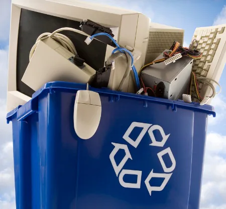A recycling bin filled with old electronics and e-waste