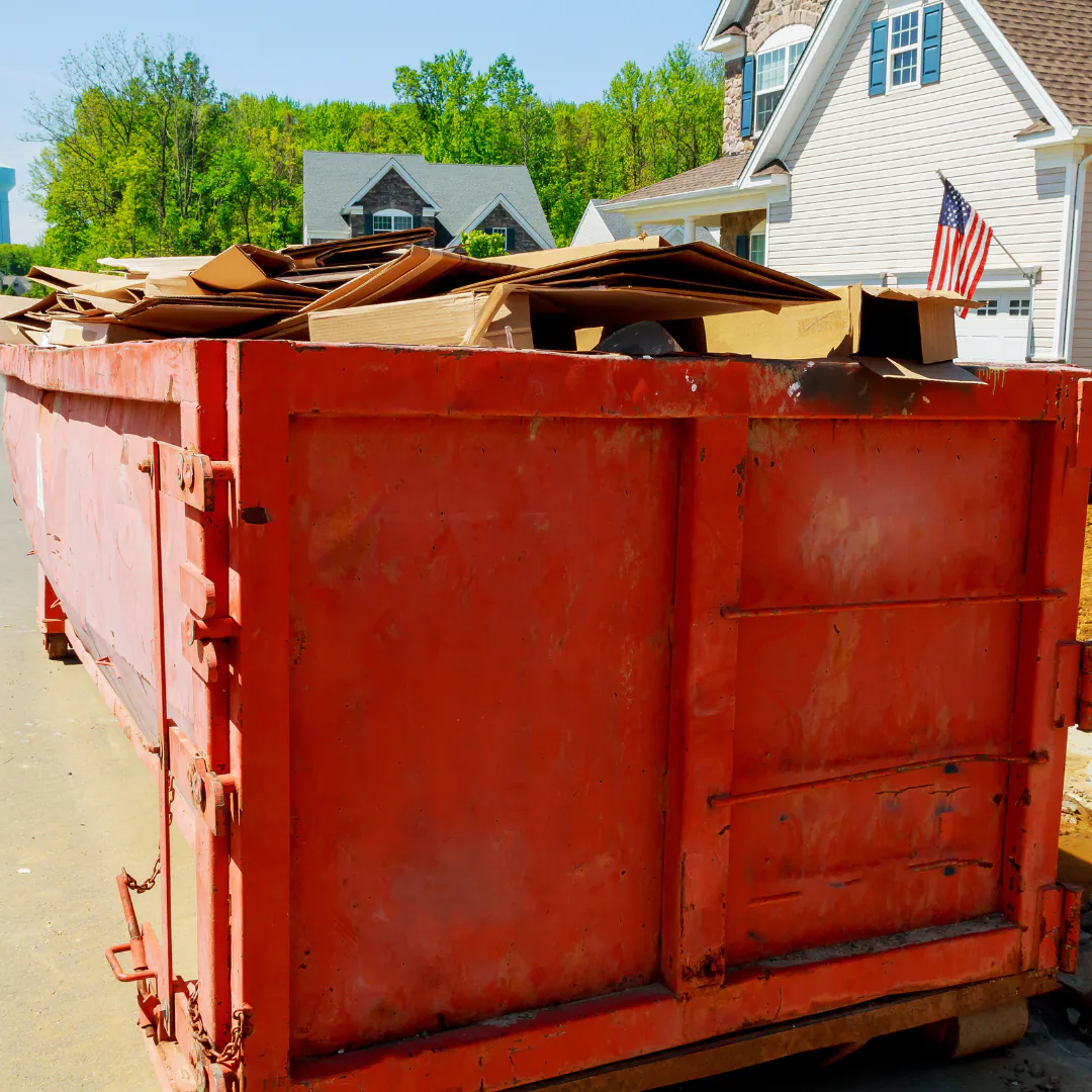 A dumpster filling up with household items during a previous Dumpster Day