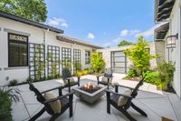 004 - 2990 Limestone Road - Outdoor patio with firepit, seating, and trellised climbing plants on the wall.