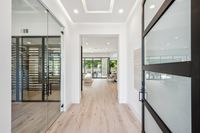 007 - 2990 Limestone Road - Entryway with open door, glass-enclosed wine room to the left, and a clear view of the bright and spacious living and dining areas