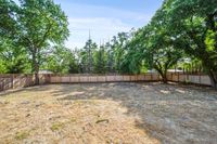 059 - 2990 Limestone Road - Large, open backyard surrounded by a wooden privacy fence