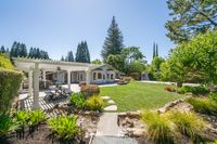 031 - 19 Warwick Court -  Landscaped backyard, stone path, pergola-covered patio with outdoor dining and kitchen