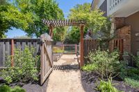 31 - 1245 Rimer Drive - Garden pathway leading through a wooden gate to the backyard