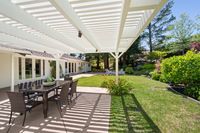013 - 3190 Bavarian Lane - Backyard patio with white pergola, outdoor dining area