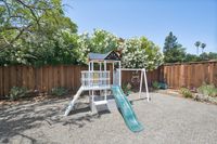 41 - 3108 Del Oceano Drive - Backyard play area with white wooden playset with a slid