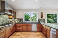 11 - 064 - 25 Haciendas Road - Kitchen with wood cabinetry, green tiled countertops and backsplash, stainless steel appliances