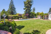 13 - 31 Old Millstone Lane - LArge level lawn and swimming pool area with trees in the background
