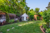 48 - 31 Old Millstone Lane - Small white shed surrounded by a stone path on the grass
