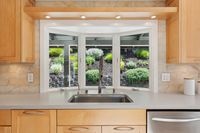 017 - 3165 Lucas Drive - Kitchen sink and a glass window that shows the cgarden area