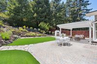 029 - 3165 Lucas Drive - Backyard patio with outdoor dining and lounge areas, plus a built-in pizza oven.