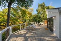 013 - 973 4th Street - Spacious wooden deck surrounded by lush green trees.