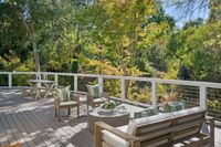 017 - 973 4th Street - A spacious outdoor deck with modern wooden seating and lush green surroundings.