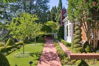 002 - 231 Sundown Terrace - Brick pathway leading through a landscaped yard with manicured trees and shrubs