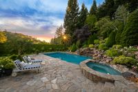 52 - 231 Sundown Terrace - Twilight view of the swimming pool area and lush trees