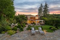 58 - 231 Sundown Terrace - Twilight view of the house with 2 lounge chairs surrounded with trees