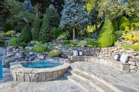 53 - 231 Sundown Terrace - Stone patio with a spa pool and landscaped garden