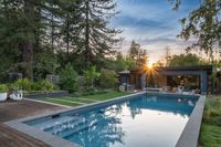 46 - 840 Broadmoor Court - Twilight view of the swimming pool area surrounded by trees