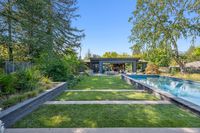 42 - 840 Broadmoor Court - Backyard with lap pool, lush landscaping, and modern patio seating.