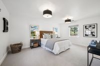 34 _ 910 Carl Road _ Bright bedroom with plush carpeting, modern ceiling lights, and a spacious layout with natural light.