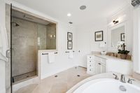 33 _ 910 Carl Road _ Primary bathroom with oversized walk-in shower, soaking tub, and clean white vanity with ample storage.
