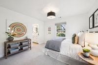 36 _ 910 Carl Road _ Sunny bedroom with plush carpeting, modern lighting, and an en-suite bath for added convenience.