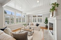 3 _ 849 Sibert Court _ Living room with large windows, plantation shutters, fireplace, and neutral furnishings