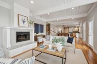 4 _ 849 Sibert Court _ Open-plan living area with fireplace, exposed beams, timber flooring, and kitchen in the background