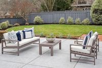 6 _ 849 Sibert Court _ Outdoor patio with cushioned seating set, coffee table, and lawn area in the background