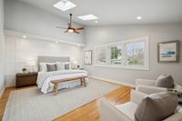 17 _ 849 Sibert Court _ Primary bedroom with high ceilings, skylights, ceiling fan, and neutral furnishings.