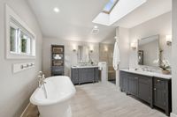 18 _ 849 Sibert Court _ Spacious primary bathroom with freestanding tub, double vanity, walk-in shower, and skylight.