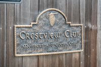 30 _ 849 Sibert Court _ Metal sign reading âCrestview Club â Members and Guests Only, Est. 1948â mounted on a wooden fence
