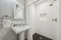 21 _ 849 Sibert Court _ Clean bathroom with pedestal sink, tiled shower, and modern fixtures