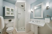 24 _ 849 Sibert Court _ Bright bathroom with glass shower, pedestal sink, and classic white finishes