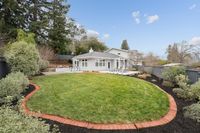 27 _ 849 Sibert Court _ Spacious backyard with manicured lawn, landscaped garden beds, and patio entertaining area