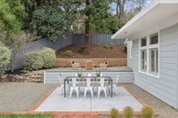 29 _ 849 Sibert Court _ Outdoor patio with dining table, gravel surround, and terraced garden seating area behind