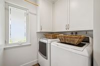33 _ 342 Constance Place _ Laundry room with washer, dryer, overhead cabinets, and window