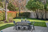 38 _ 342 Constance Place _ Backyard patio with outdoor dining set and landscaped lawn