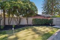 36 _ 342 Constance Place _ Backyard putting green with landscaped border and privacy fence