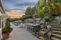 2 _ 1089 Rahara  Drive _ Twilight view of the backyard with patio, pool, and outdoor seating area