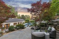 42 _ 1089 Rahara  Drive _ Twilight view of outdoor area with seating, pool, landscaping, and surrounding trees