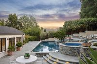 51 _ 1089 Rahara  Drive _ Twilight view of outdoor area with pool, seating, landscaping, and surrounding trees