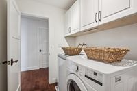 35 _ 665 Sky Hy Circle _ Laundry room with upper cabinetry and side-by-side washer and dryer setup