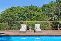 36 _ 665 Sky Hy Circle _ Poolside deck with two lounge chairs and cable railing overlooking tree-lined surroundings