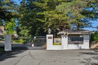 38 _ 665 Sky Hy Circle _ Gated community entrance with security access, mailbox station, and mature redwood surroundings