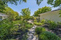 32 _ 4 Crest Road _ Garden pathway leading to patio and outdoor seating area