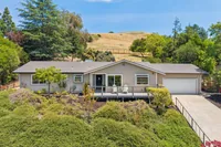 1 _ 8 Ketelsen _ Front exterior with driveway, attached garage and hillside backdrop