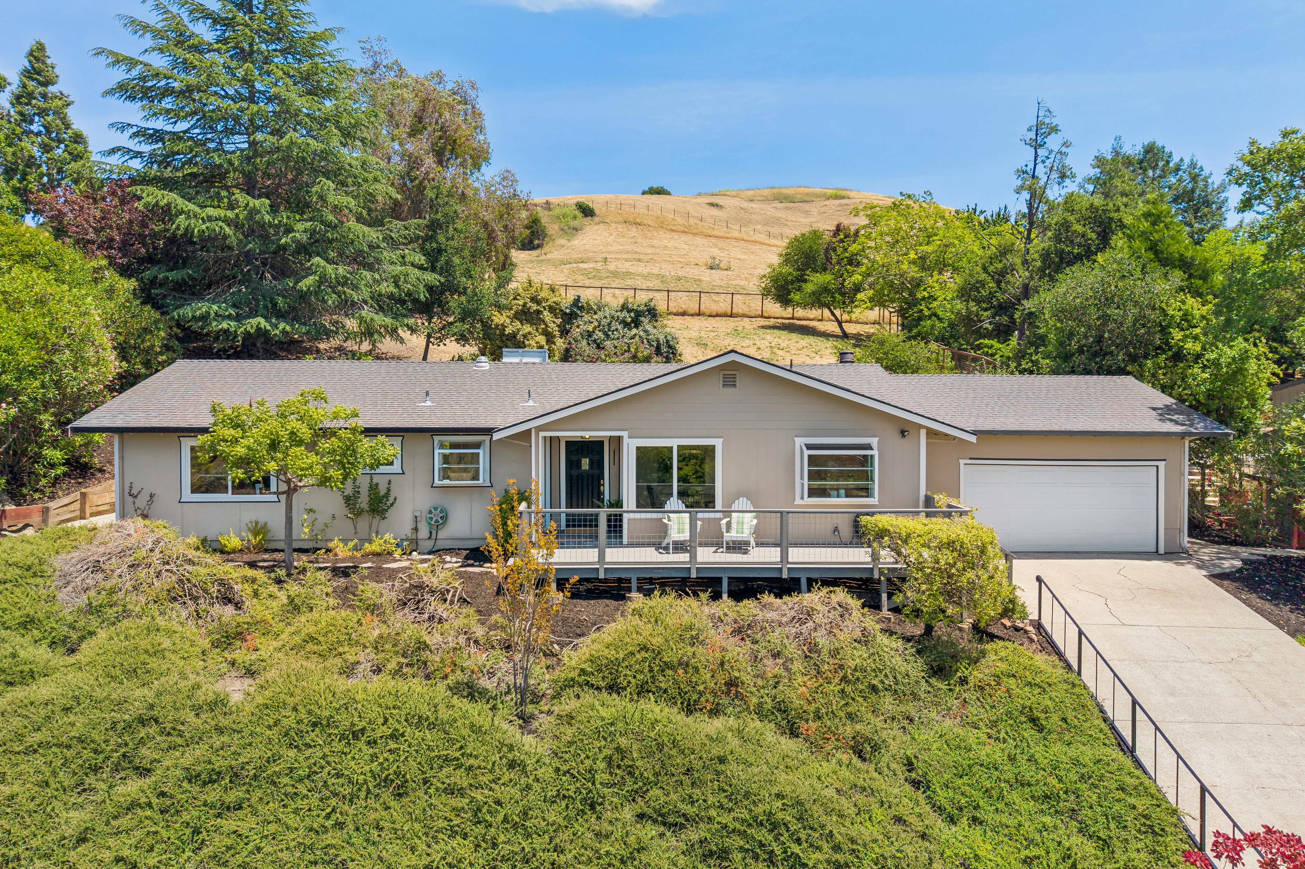 1 _ 8 Ketelsen _ Front exterior with driveway, attached garage and hillside backdrop