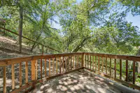 32 _ 996 Hawthorn Drive  _ Wood deck with railing and wooded surroundings