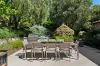 17 _ 31 Sandy Court _ Outdoor dining area with built-in barbecue and landscaped surroundings