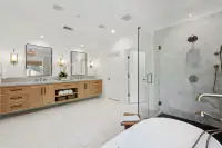 30 _ 31 Sandy Court _ Primary bathroom with dual vanities, soaking tub, and glass-enclosed shower